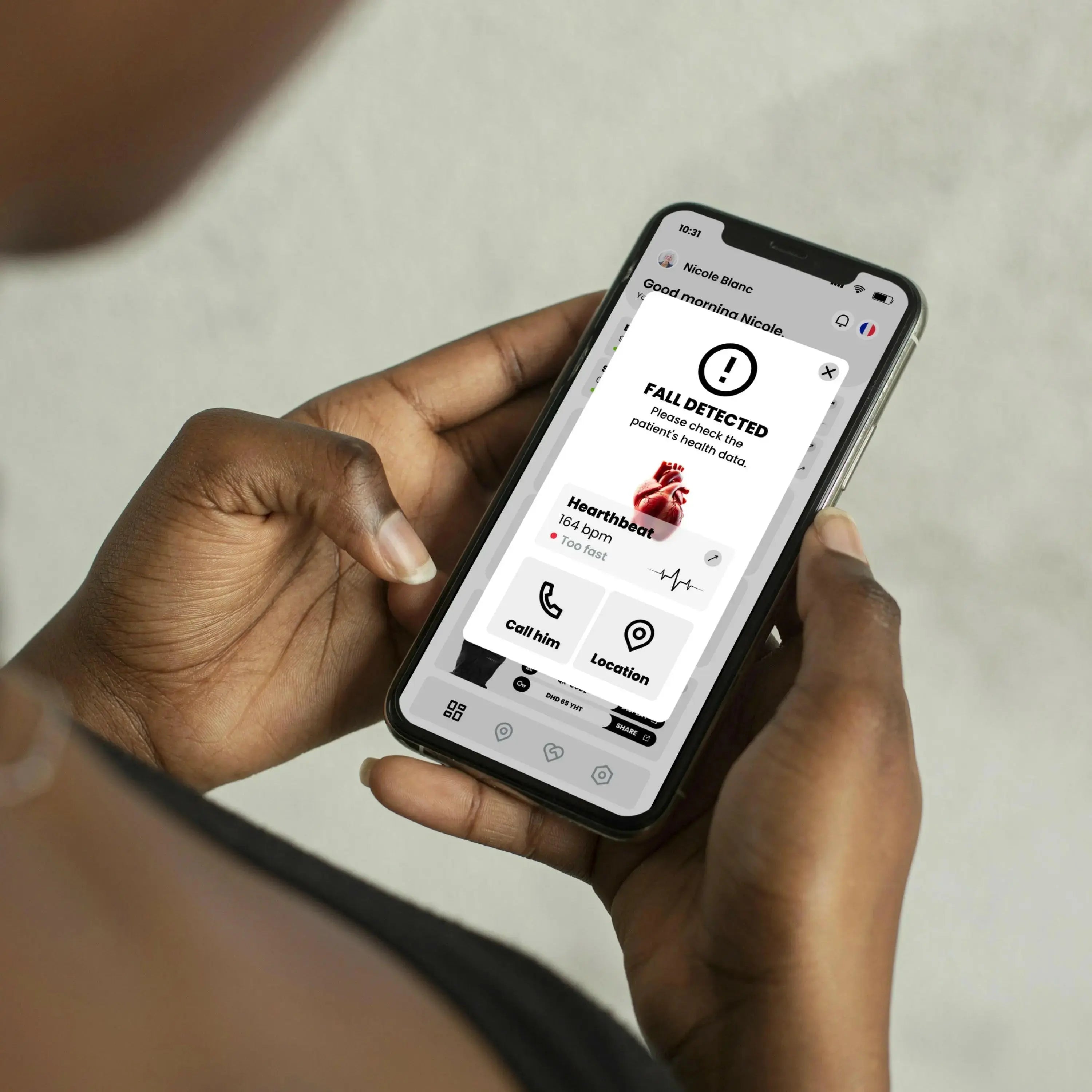 Chutex app on phone displaying fall alerts and connected health data, made in France